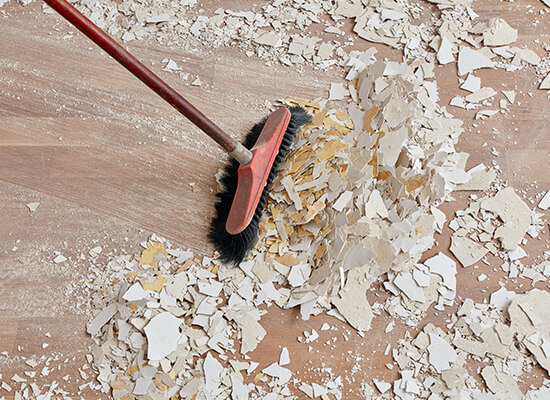 passing the broom on a dirty floor